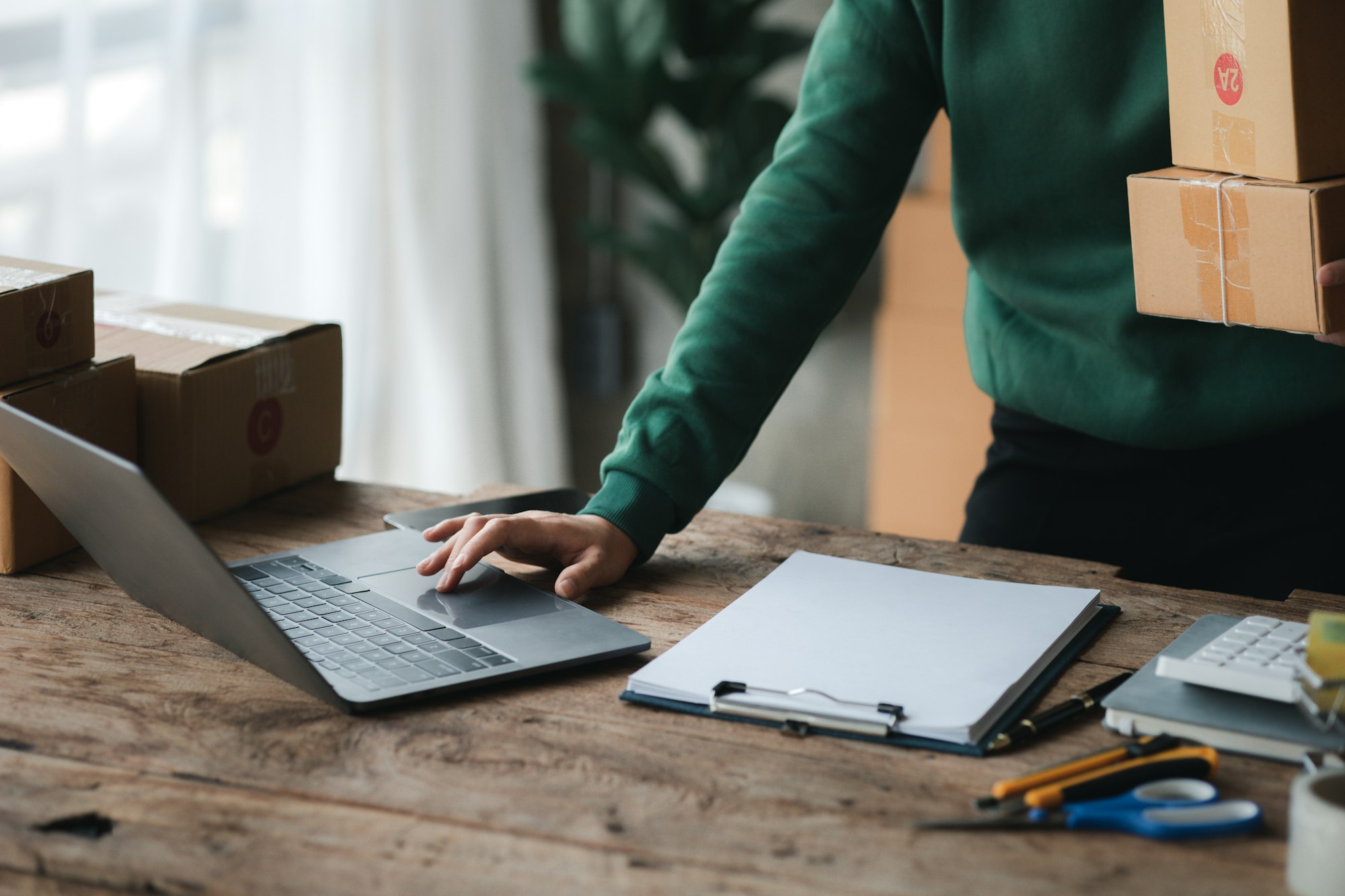 A person is using a laptop. Business owner opens an online store.